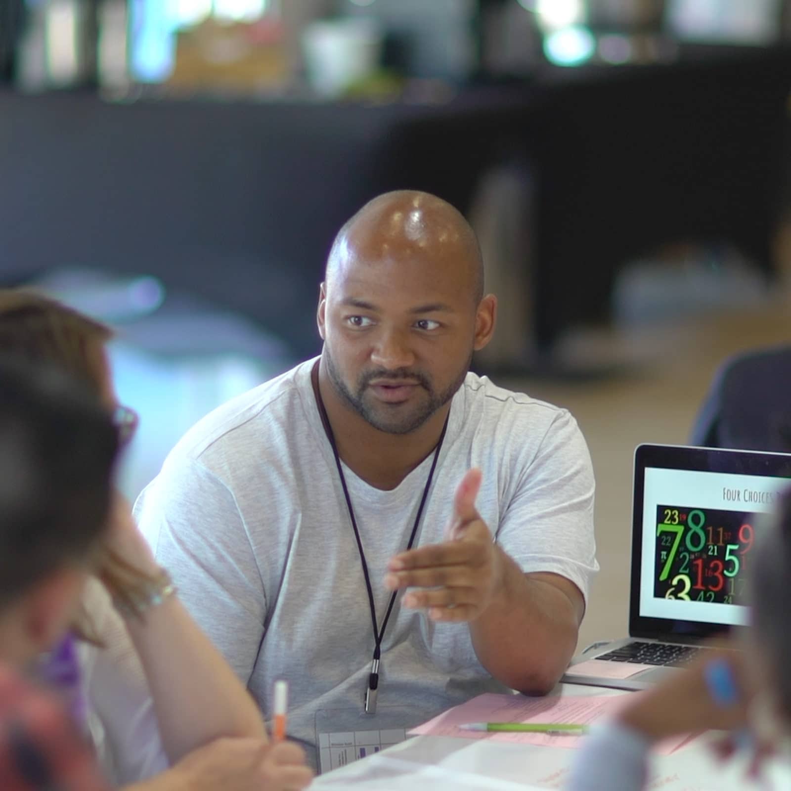 Improvement coach Curtis Taylor explains something to his colleagues.